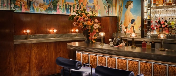 A beautiful mural surrounding a burl wood paneled bar