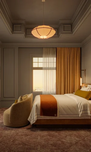 An elegant hotel room with warm, rich ochre earth tones, textile carpet, wood headboard with floating marble-topped night stands, and soft pendant lighting.