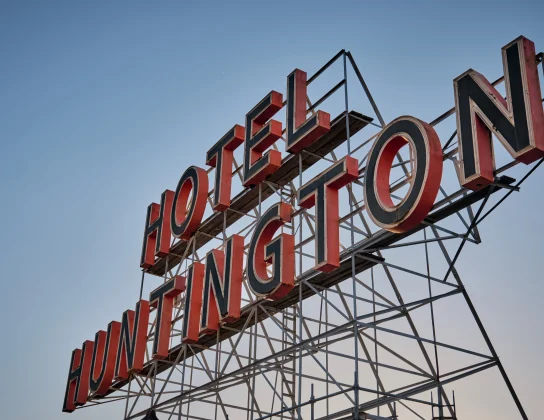 The Huntington Hotel signage positioned against a clear blue sky