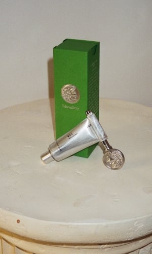 008 MonasteryMade skincare lotion sits atop a stone plinth