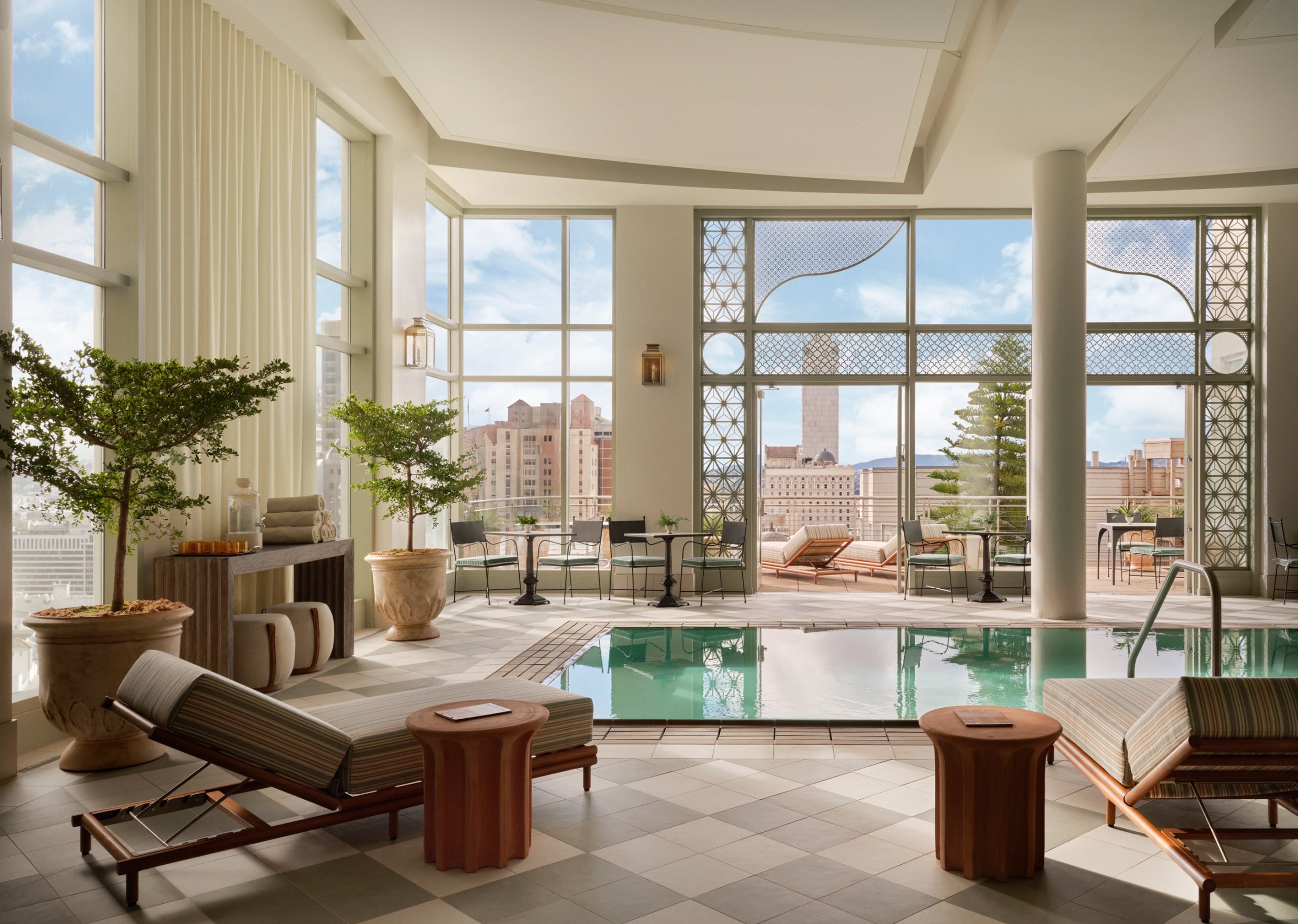 An indoor luxury swimming pool area with a checkered tile floor
