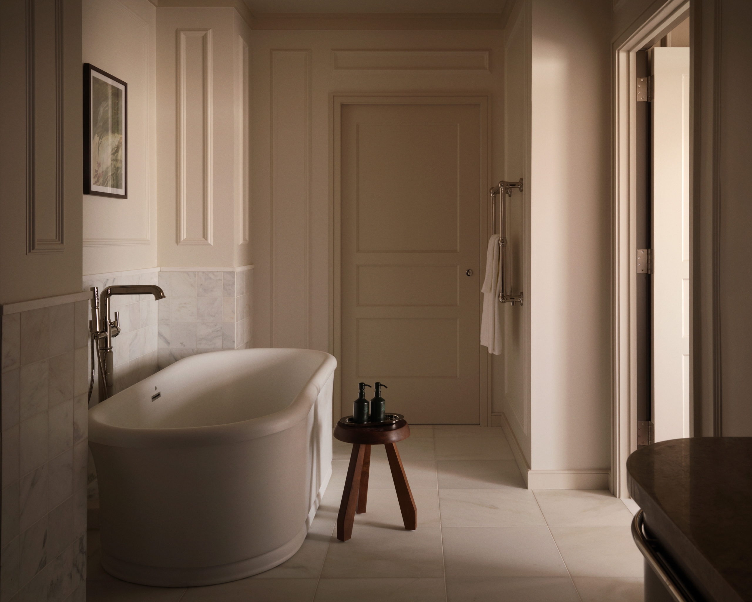 An elegant bathroom features a freestanding white oval bathtub