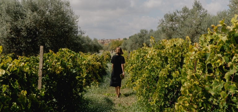Woman walking through vineyard