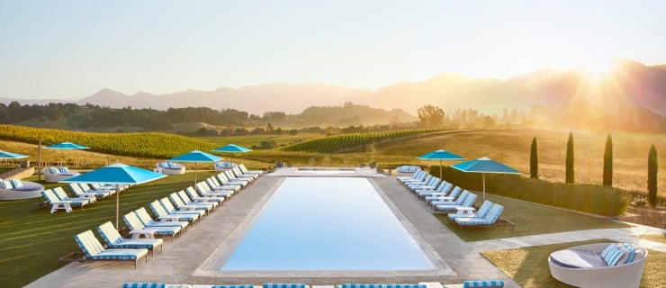 Pool at Carneros Resort and Spa, surrounded by rolling vineyard hills in Napa Valley